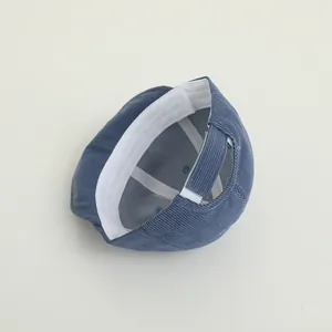 Detail of baby corduroy cap showing inner sweatband and adjustable velcro strap