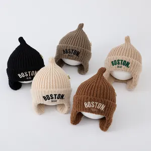 Detail view of winter knitted baby hats with BOSTON embroidery in five diverse colors
