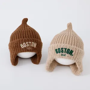 Detailed view of BOSTON 1630 embroidery on warm knit earflap hats for kids