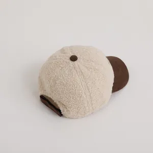 Detail of winter sherpa baseball cap with contrast brown corduroy brim and texture