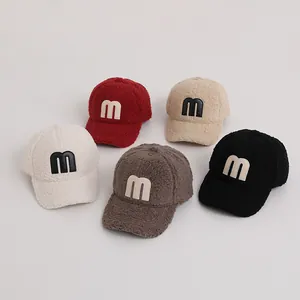 Fleece baseball caps for kids in five colors featuring embroidered M letter patch
