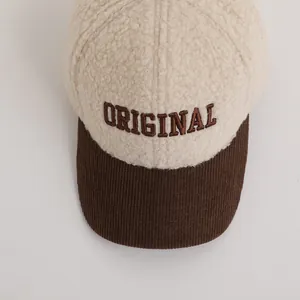 Close-up of winter child baseball cap with sherpa fleece texture and letter embroidery