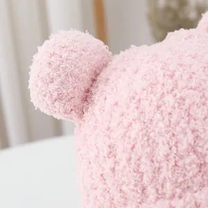 Close-up of pink sherpa fleece fabric showing soft texture and cozy ear detail