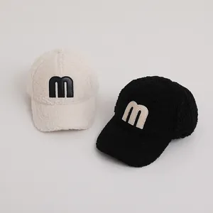 Fleece winter baseball caps for kids featuring fuzzy texture and 3D 'M' letter patch