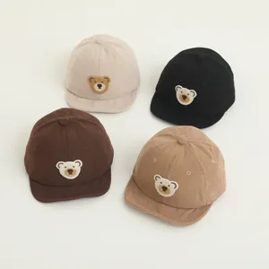 Detail of four baby corduroy baseball caps with cute 3D teddy bear embroidery in various colors
