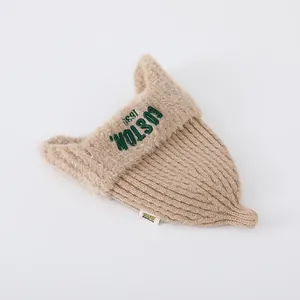 Detailed knit texture and plush beige fleece trim of a khaki Boston earflap beanie