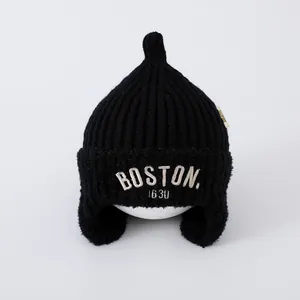 Black knitted baby beanie with earflaps, Boston embroidery, and pointy top design