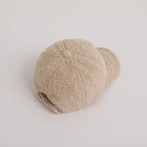 Detail of warm polar fleece baseball cap showing soft teddy velvet texture and adjustment strap