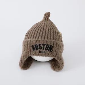 Detail of brown knit aviator hat with BOONT 1630 embroidery and warm ear flaps