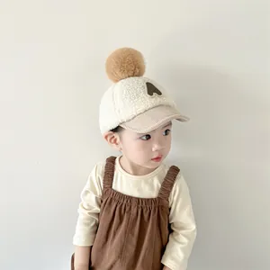 Détail du bonnet d'hiver pour bébé avec pompon et broderie lettre A en peluche