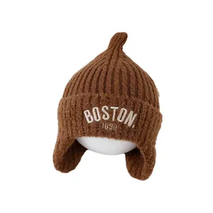 Brown knit winter hat for children with earflaps and Boston 1630 embroidery