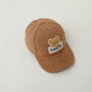 Close-up of brown teddy fleece kid's baseball cap with lucky bear embroidery patch