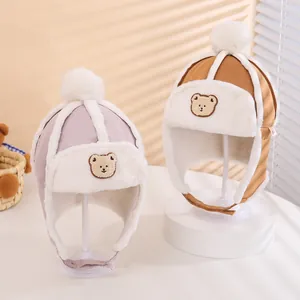 Plush winter trapper hats for kids with cartoon bear embroidery and faux fur lining