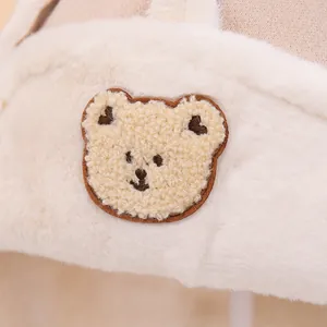 Plush cream white winter hat for kids with cute bear patch and soft faux fur texture