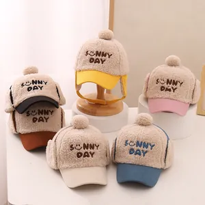 Close-up of children's plush earflap hats in five colors with Sunny Day embroidery