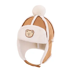 Brown toddler trapper hat with bear patch, faux suede exterior and warm fleece lining