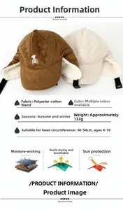 Detail view of winter earflap hat for kids featuring bear embroidery and quilted texture