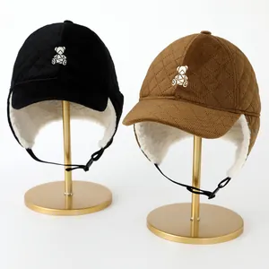 Detailed quilted texture and fluffy fleece lining of the bear earflap winter baseball cap