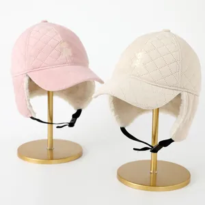 Kids thermal trapper hat with quilted fabric and warm fleece lining in pink and beige