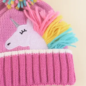 Pink knit baby unicorn hat with colorful yarn mane and warm winter embroidery