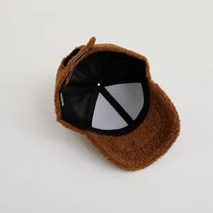 Detail view of the brown teddy fleece kid's baseball cap with adjustable velcro strap