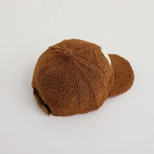 Close-up of brown lamb wool texture on kids baseball cap with soft fleece finish