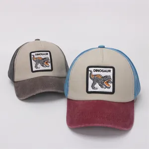 Detail of kids baseball cap featuring dinosaur patch embroidery and washed fabric texture