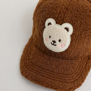 Warm brown fleece baseball cap for children featuring a cute cartoon bear embroidery