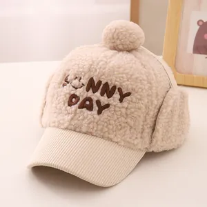 Detail of plush winter hat for kids with earflaps and Sunny Day smiley embroidery