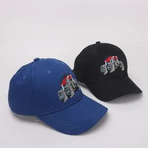 Detailed embroidery of a colorful monster truck on blue and black cotton baseball caps