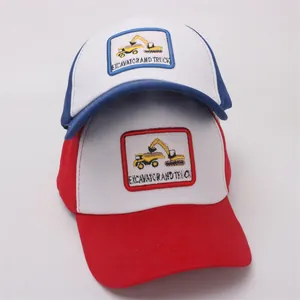 Detail of kids baseball caps featuring excavator embroidery in blue and red colors