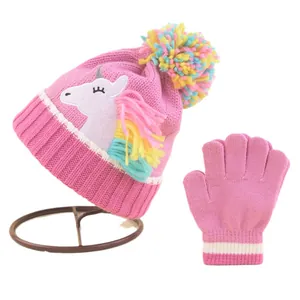 Pink knit unicorn beanie and mittens set for girls featuring colorful faux fur pom-poms