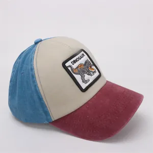 Detail of tricolor dinosaur embroidery on washed cotton baseball cap for kids