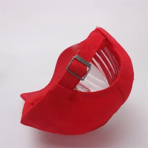 Detail view of red cotton baseball cap with hollow back design and metal buckle adjustment