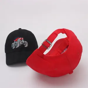 Detail of adjustable metal buckle on red baseball cap and monster truck embroidery