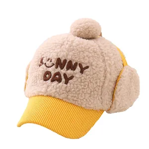 Winter kids earflap hat with Sunny Day embroidery and soft plush pompom in beige