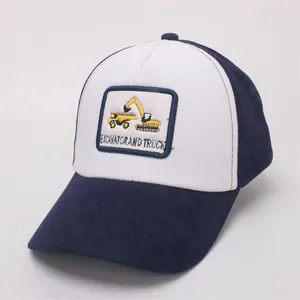 Detail view of cotton baseball cap with embroidered yellow excavator and truck patch
