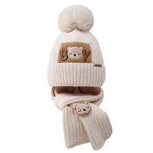 Winter knit baby beanie and scarf set with cute bear patch and soft pom-pom detail