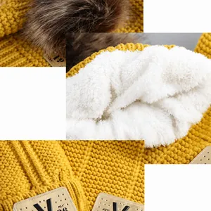 Ginger yellow kids knit beanie with fleece lining, faux fur pompom, and warm ear protection