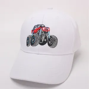 Detail of white cotton baseball cap featuring colorful monster truck embroidery on the front