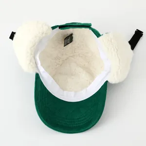 Gorro de invierno de pana verde para niños con forro de lana de cordero blanca y orejeras