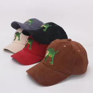 Detail of colorful children's cotton baseball caps with cartoon dinosaur embroidery