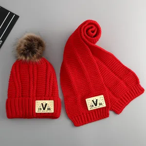 Winter baby knit hat and scarf set in bright red with faux fur pompom and V-patch
