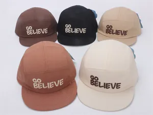 Detail of 5-panel kids baseball caps featuring GO BELIEVE embroidery in five diverse colors