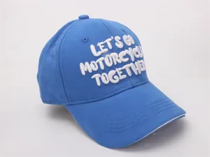 Detail of blue cotton baseball cap with white 3D embroidery and reinforced stitching
