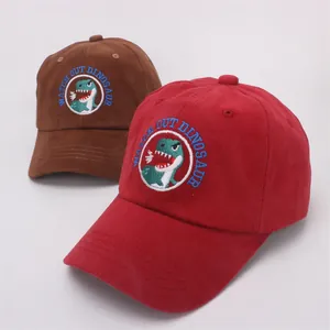 Kids cotton baseball caps in brown and red with cartoon dinosaur embroidery