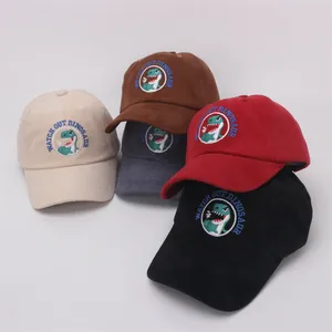 Detail of multi-colored cotton baseball caps featuring dinosaur embroidery for kids