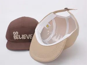 Detail view of cotton five-panel baseball caps with 3D embroidery and adjustable strap