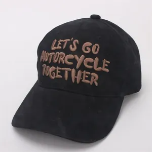 Close-up of Let's Go Motorcycle embroidery on a black twill cotton baseball cap