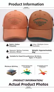 Detail view of cotton kids baseball caps in orange and brown with embroidery